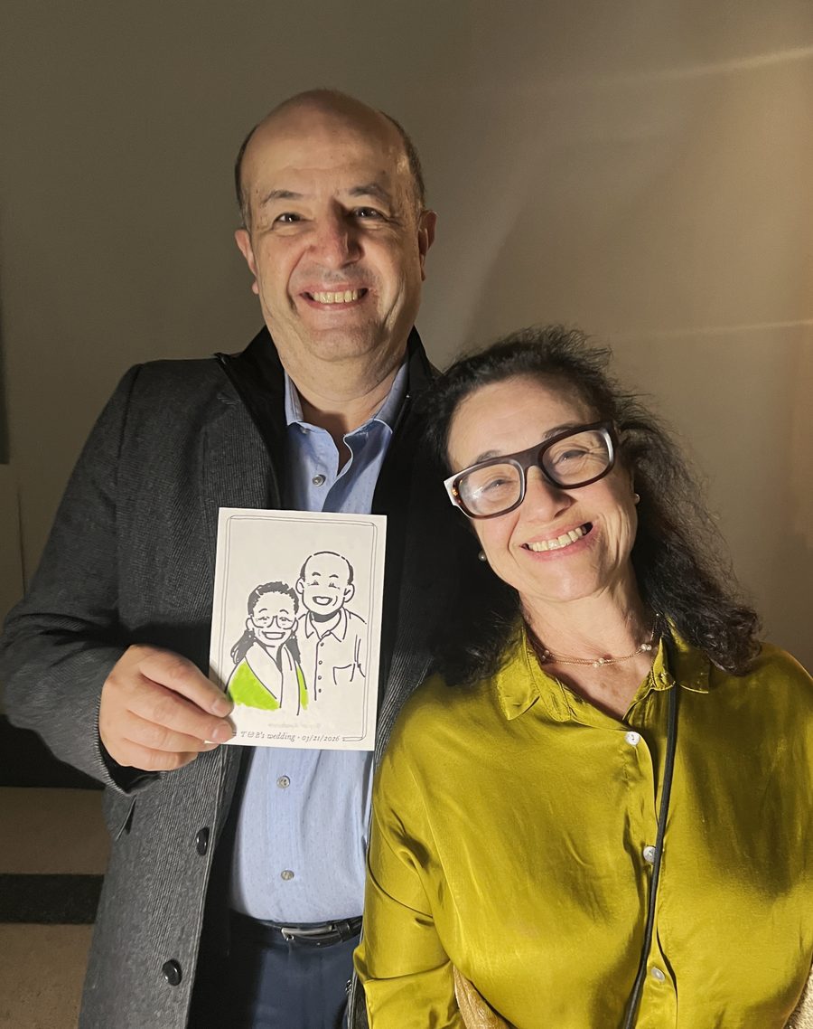 Couple holding their personalized live sketch portrait