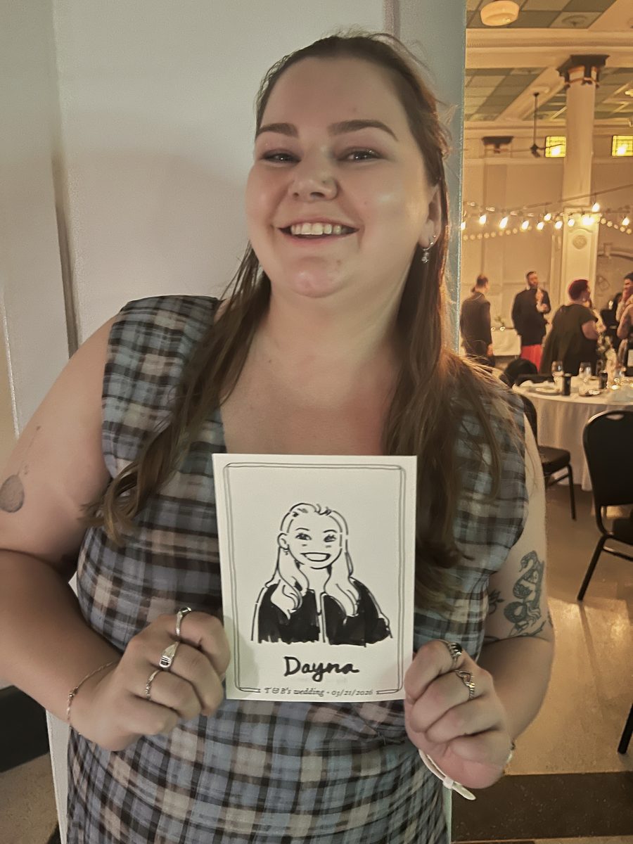 Wedding guest holding her finished portrait sketch